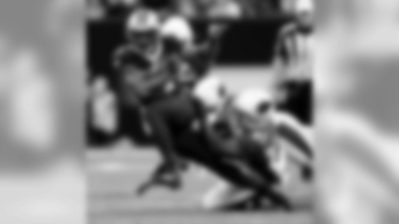 Saints running back Dwayne Washington runs though the Cardinals defense.