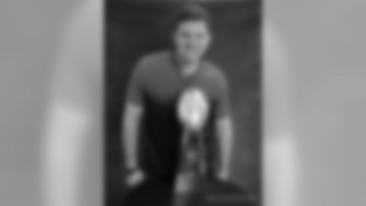 New Orleans Saints tackle Jon Stinchcomb poses with the XLIV Super Bowl trophy in 2019.