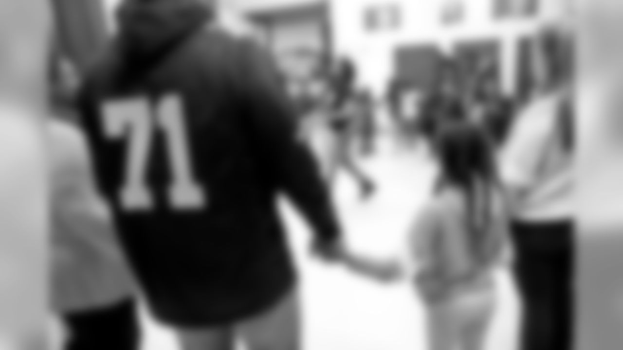 New Orleans Saints players teamed up with Dudley DeBosier for a coat giveaway at the Youth Empowerment Project.