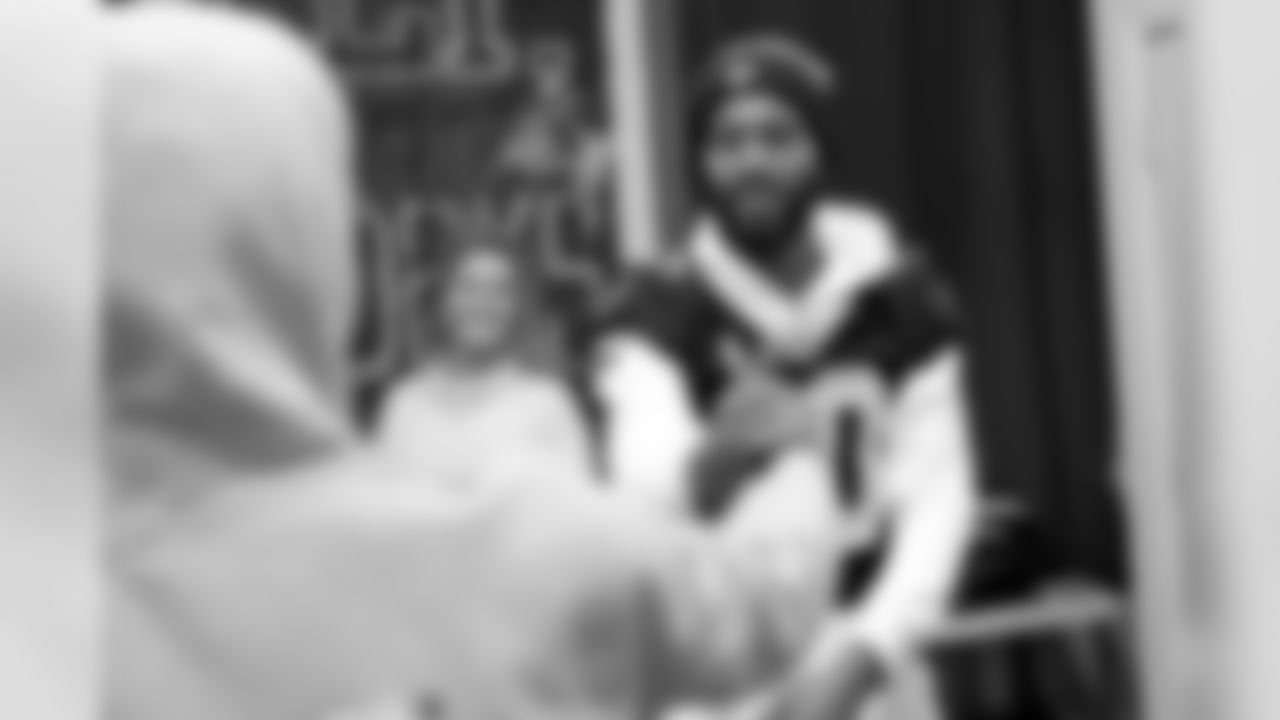 New Orleans Saints players teamed up with Dudley DeBosier for a coat giveaway at the Youth Empowerment Project.