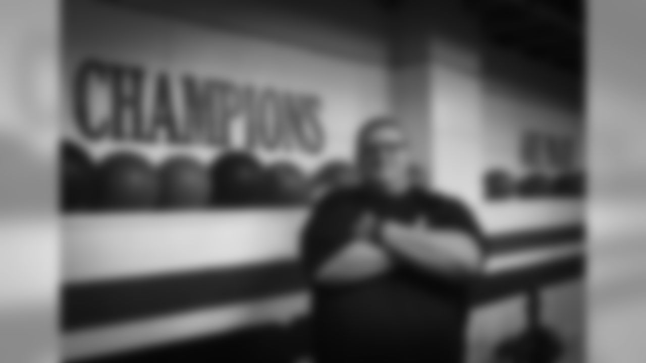 Coach Gino Mariani poses for a portrait in the weight room of Highland High School where he once coached Taysom in football.