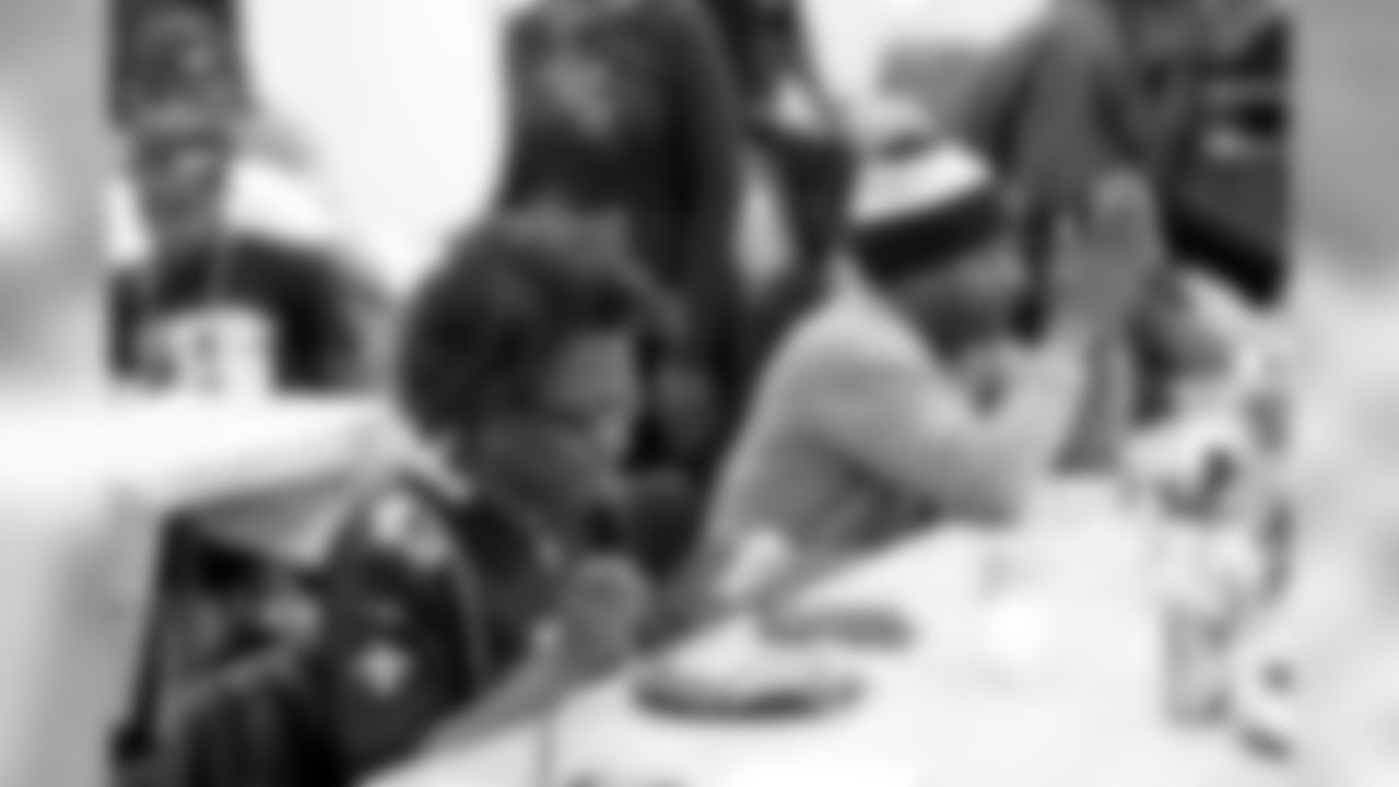 New Orleans Saints defensive end Cameron Jordan visits with students enjoying a Thanksgiving dinner courtesy of the Dudley DuBosier law firm at the Youth Empowerment Project adult education center on Tuesday, November 19, 2019.