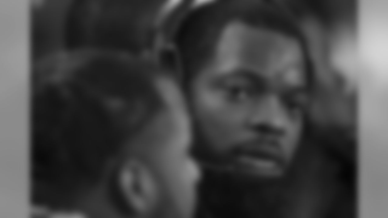 Michael Bennett uses a headset to confer with coaches in the booth during the fourth quarter.