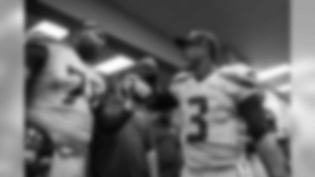 Quarterback Russell Wilson congratulates his left tackle Russell Okung in the Seahawks locker room after the win.