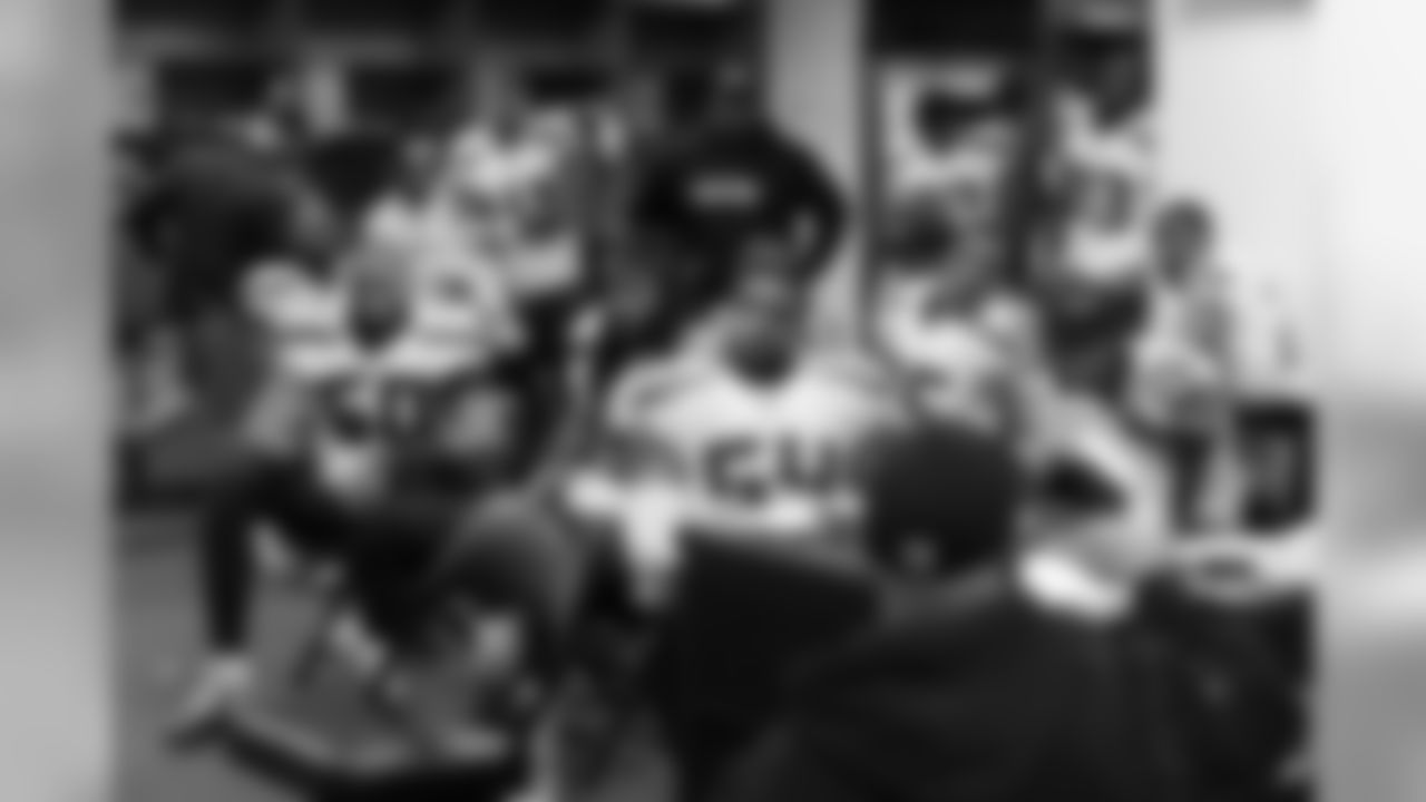 in the Seahawks locker room at halftime, the defense watches the screen as defensive coordinator Kris Richard reviews strategy.
