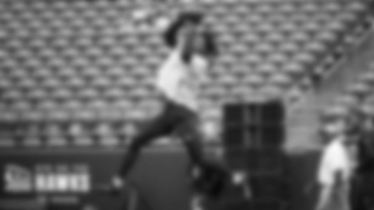 Cornerback Tariq Woolen leaps high during early pregame wamups.