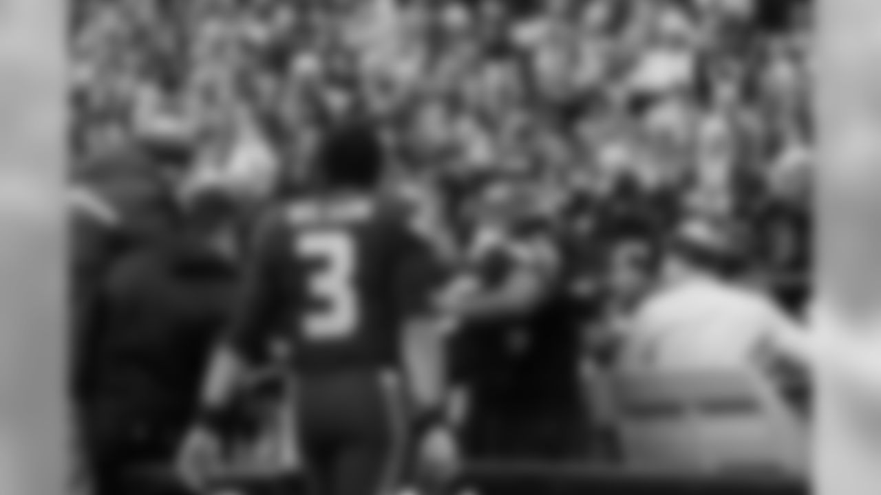 Seattle receiver Tyler Lockett signals to the crowd as he is helped to a cart to be taken off the field after injuring his leg in the second quarter.
