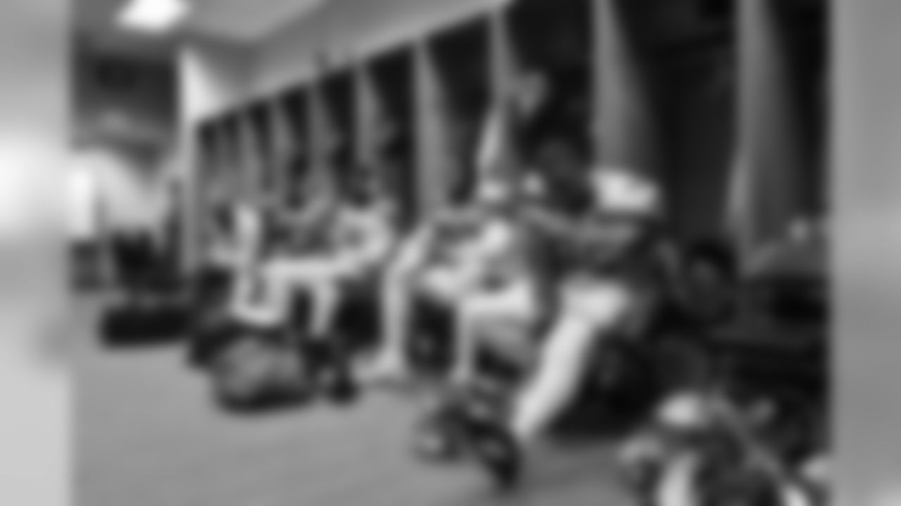 Dressed in their Action Green uniforms for Thursday Night Football's Color Rush, defensive linemen (right to left) Dion Jordan, Nazair Jones, Garrison Smith, Branden Jackson and Marcus Smith sit in front of their lockers prior to kickoff.