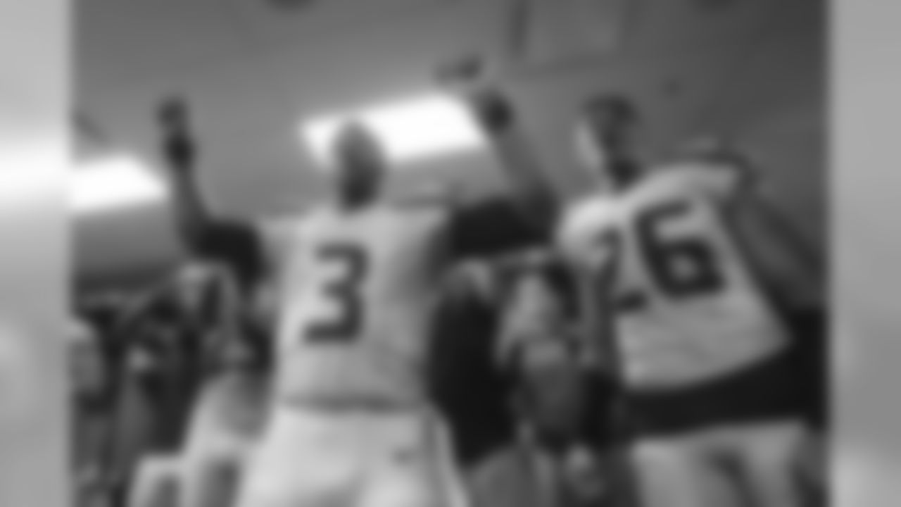 In happy visitor's locker room, Russell Wilson and Cary Williams celebrate.