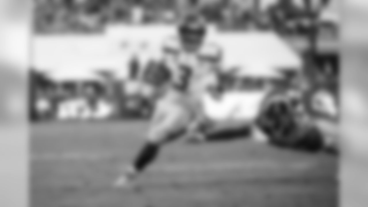 Seattle's Russell Wilson escapes an attempted tackle by Rams safety Marqui Christian.