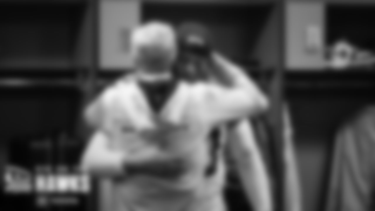 Head coach Pete Carroll hugs linebacker Uchenna Nwosu.