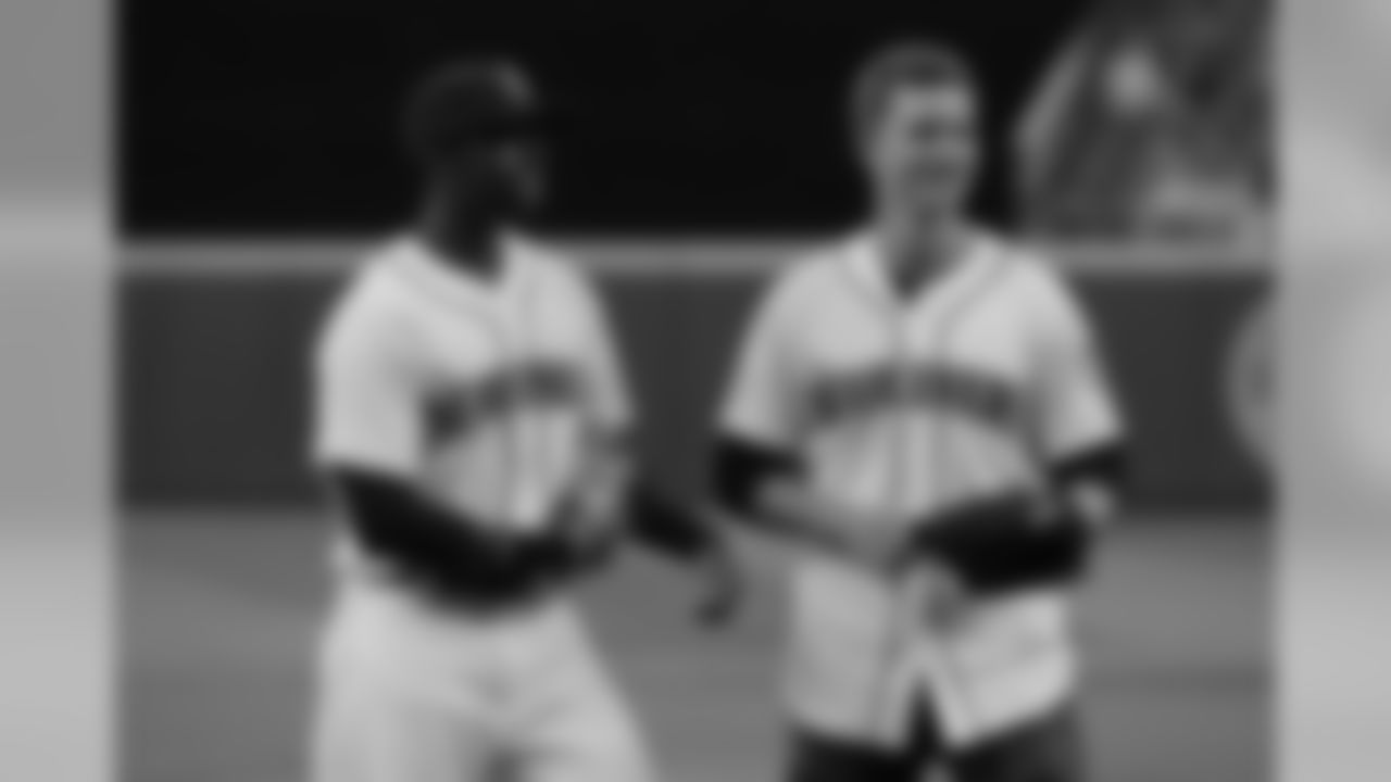 Seattle Mariners outfielder James Jones, left, stands with Steven Hauschka, a kicker for the Seattle Seahawks NFL football team, after Hauschka threw out the first pitch of a baseball game, Tuesday, Sept. 8, 2015, in Seattle. (AP Photo/Ted S. Warren)