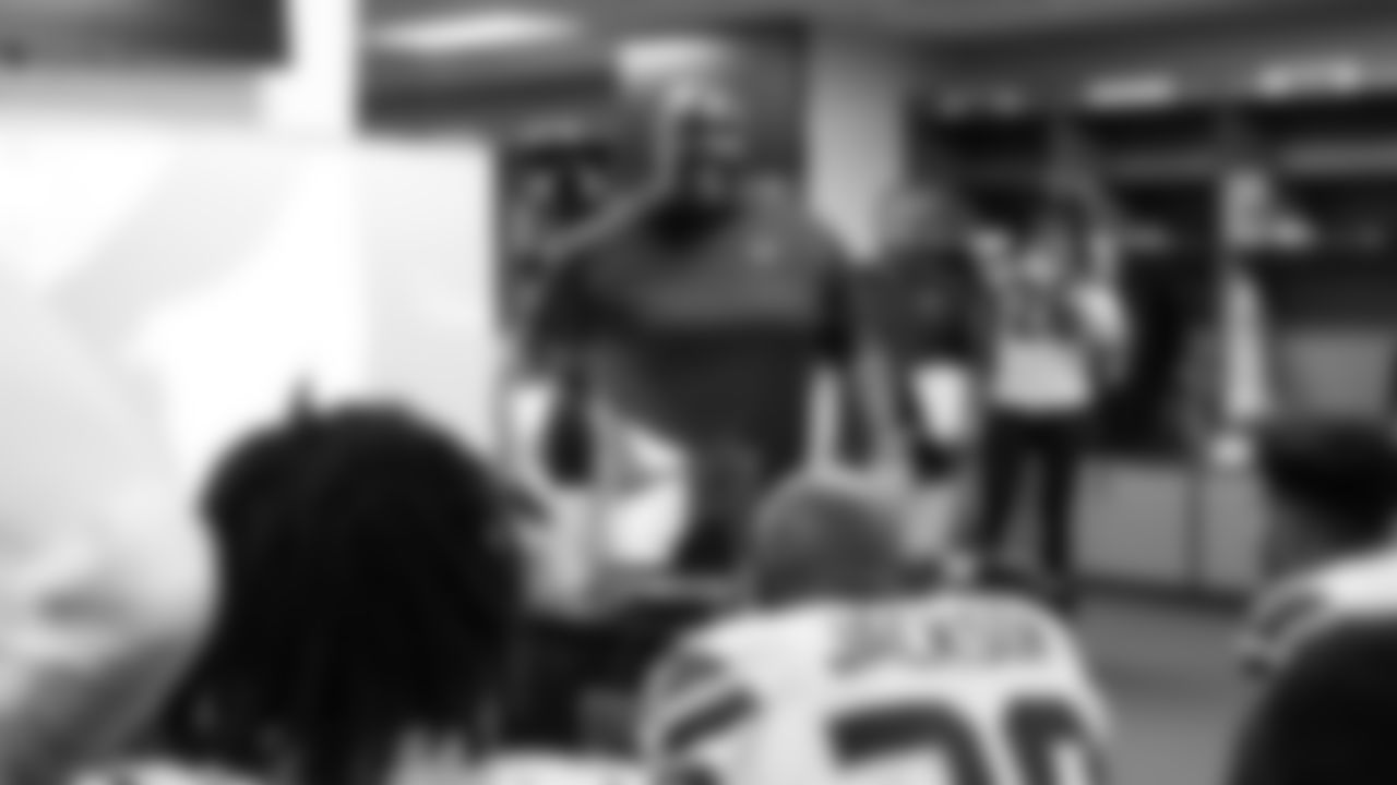 Defensive coordinator Clint Hurtt gives instructions in the locker room at halftime.