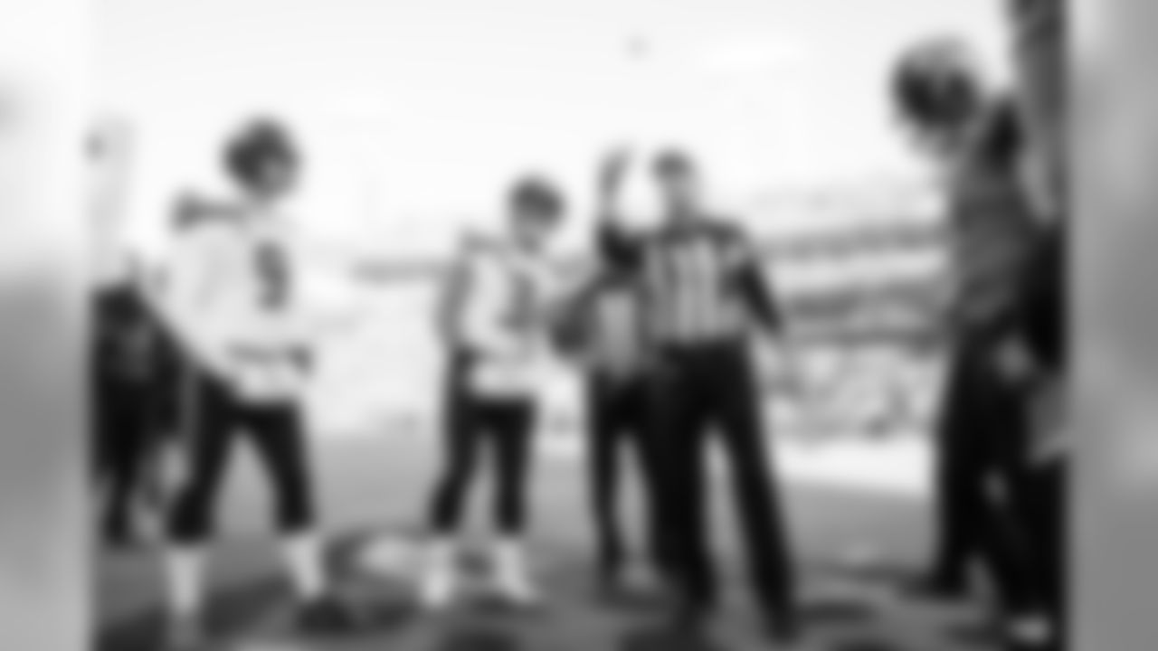 Seahawks captains Jon Ryan and Russell Wilson watch as head referee Gene Steratore flips the coin during the opening coin toss.
