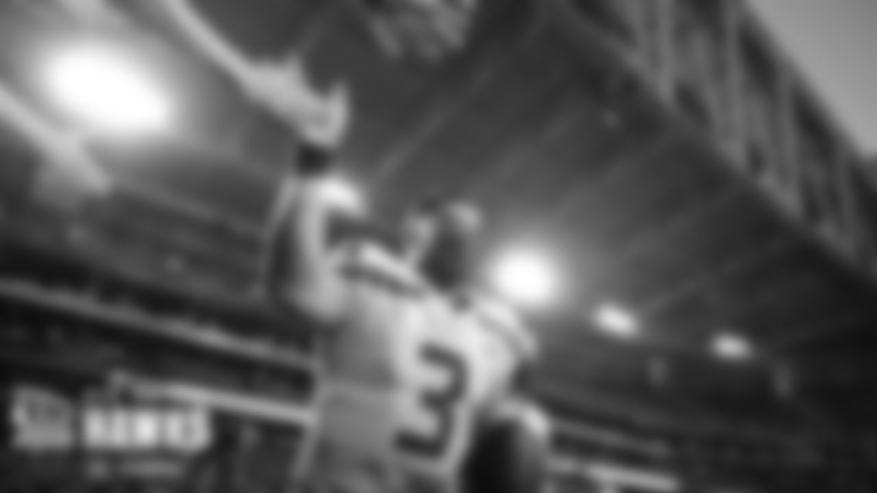 Seahawks quarterback and captain Russell Wilson takes a victory lap and acknowledges 12s as he heads to the locker room after winning the season finale.