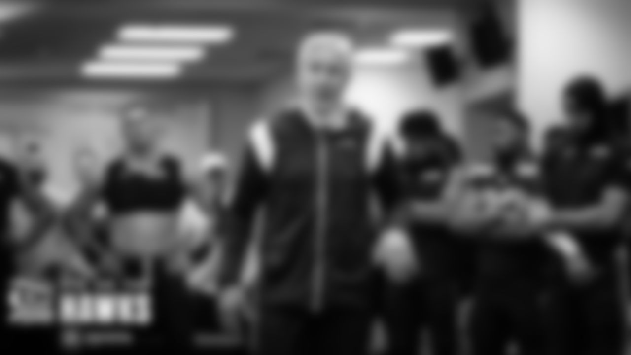 Head coach Pete Carroll talks to his team in the locker room after the game.