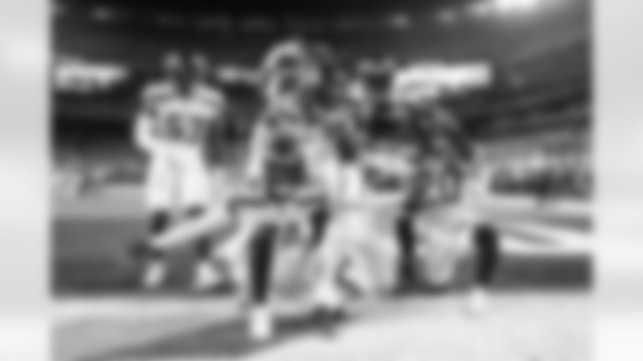 Seahawks defenders celebrate a strip sack and fumble recovery in the end zone. Jordyn Brooks recovered the fumble caused by Mario Edwards.