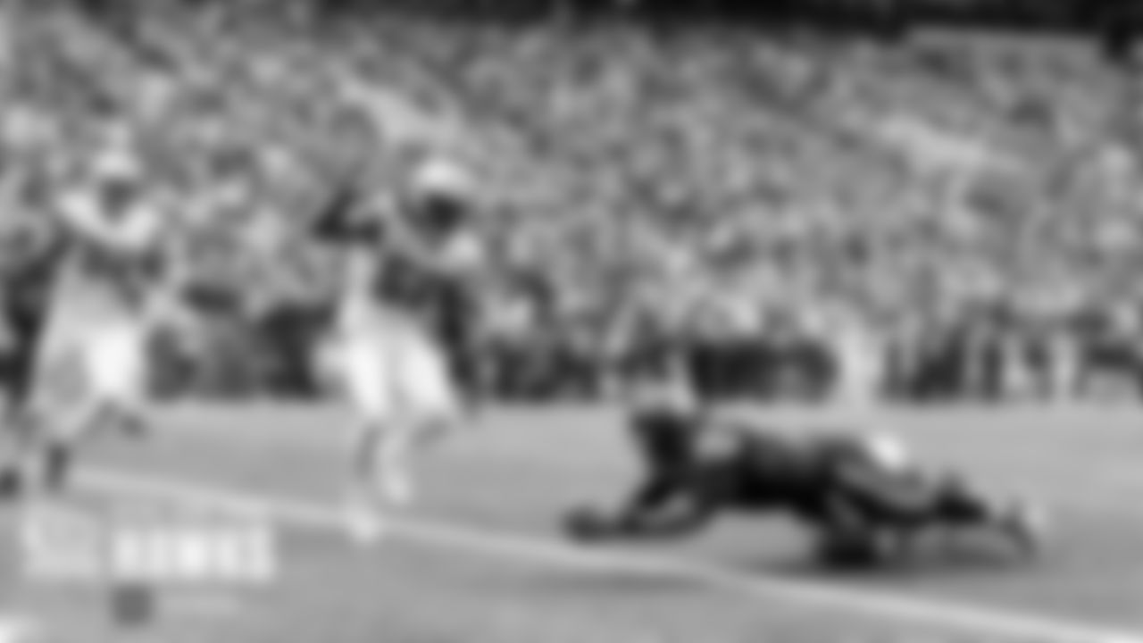 Seattle's Russell Wilson scores on a two-yard run in the fourth quarter to cut the Seahawks deficit to 27-14.