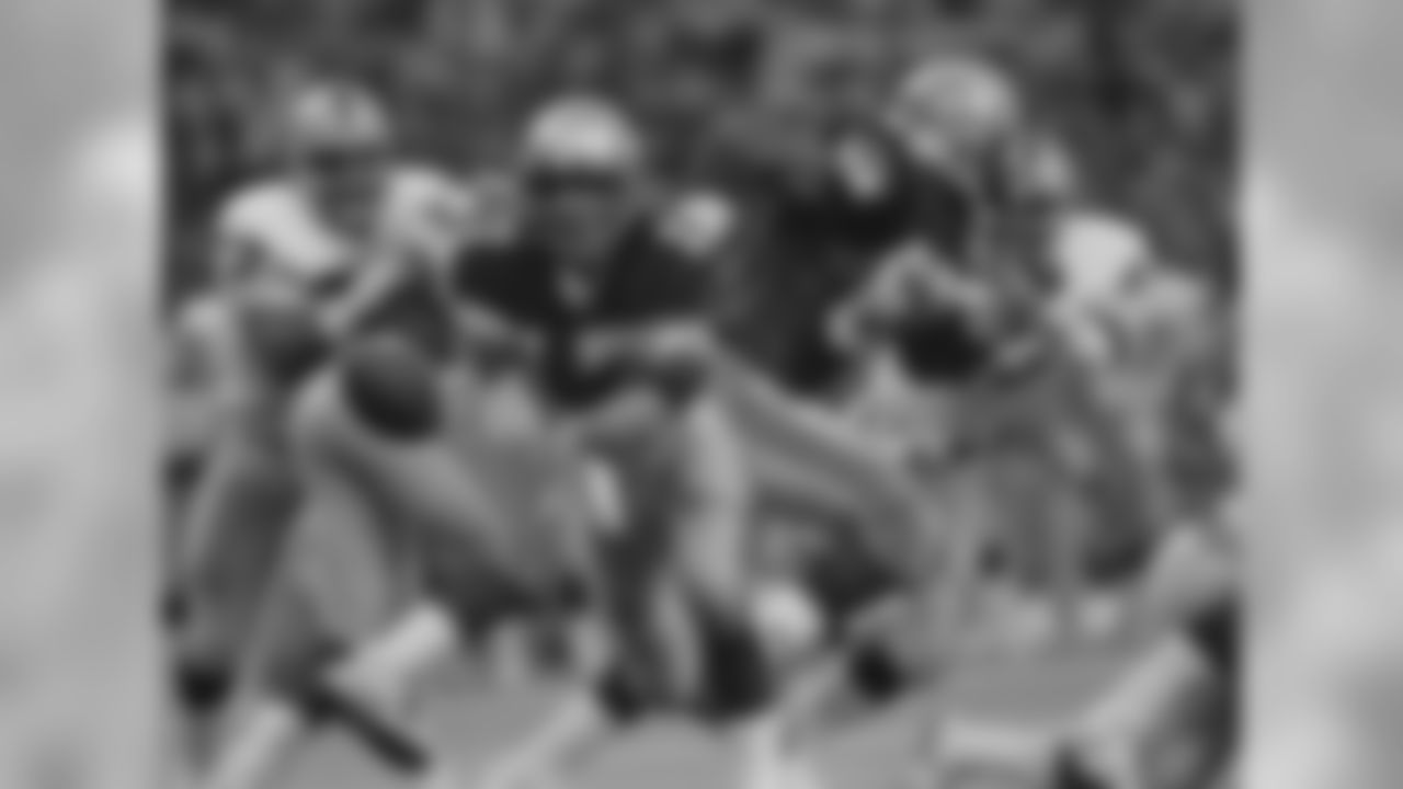Seattle's Dave Krieg (17), pitches out to a running back behind the blocking of Reggie McKenzie in NFL game, Nov. 13, 1984 in Seattle against the Los Angeles Raiders. Moving in is Lyle Alzado of the Raiders. Seattle won 17-14. (AP Photo/Barry Sweet)