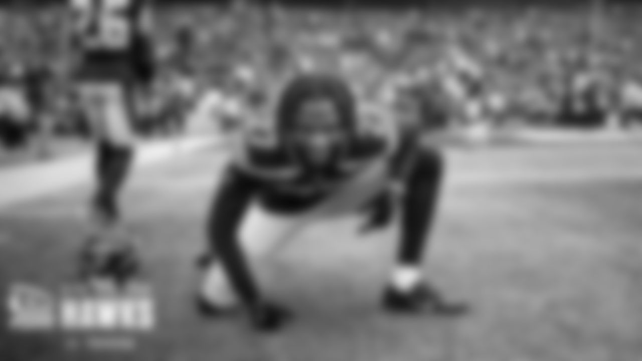 Cornerback Tariq Woolen stretches during pregame.