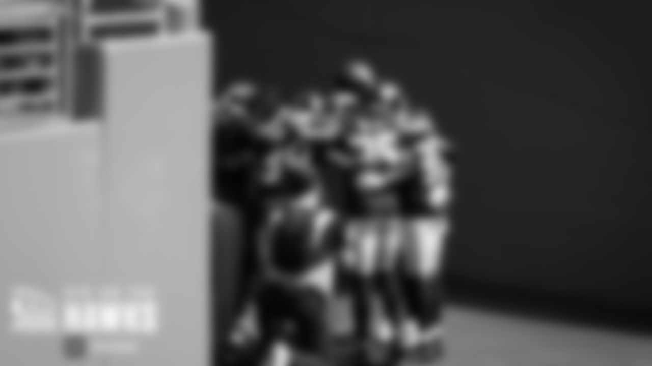 Seahawks defensive backs huddle before taking the field.