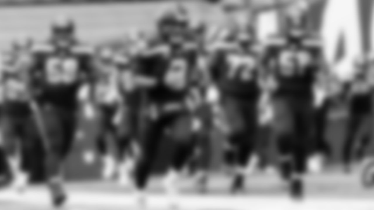 Seahawks quarterback Russell Wilson leads the team onto the field.