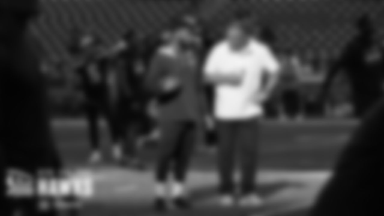 Defensive back Tre Brown chats with assistant coach Pat McPherson during early warmups.