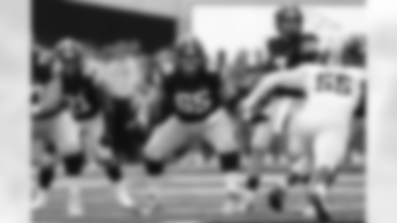FILE - Iowa offensive lineman Tyler Linderbaum (65) looks to make a block during the first half of an NCAA college football game against Indiana in Iowa City, Iowa, Saturday, Sept. 4, 2021. Lindenbaum was selected to The Associated Press All-Big Ten team in results released Tuesday, Dec. 7, 2021. (AP Photo/Charlie Neibergall, File)