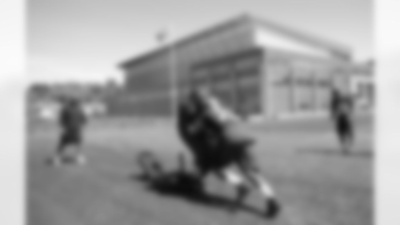 Julius Jones hits the sled during Friday's practice