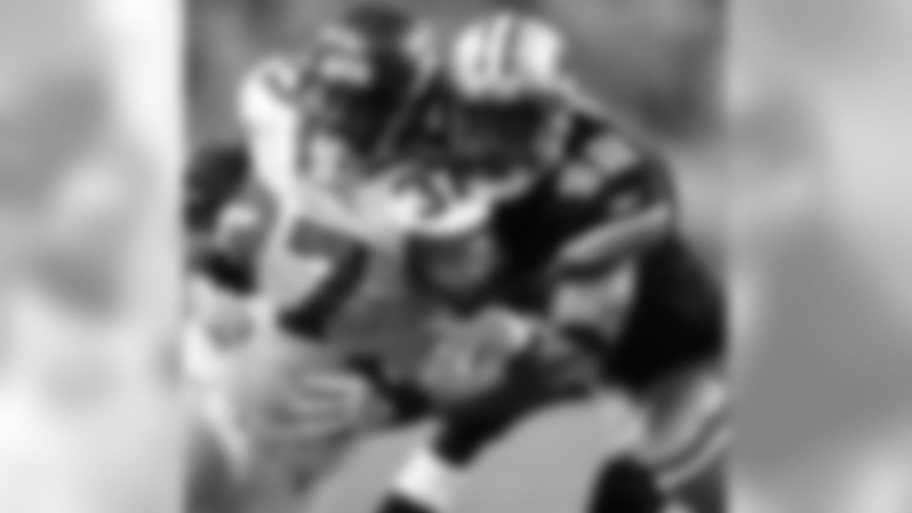 Seattle Seahawks running back Shaun Alexander (37) is muscled out of bounds by Detroit Lions safety Terrence Holt (42) after an 8-yard gain in the second quarter of an NFL football game Sunday, Sept. 10, 2006, in Detroit. (AP Photo/Duane Burleson)