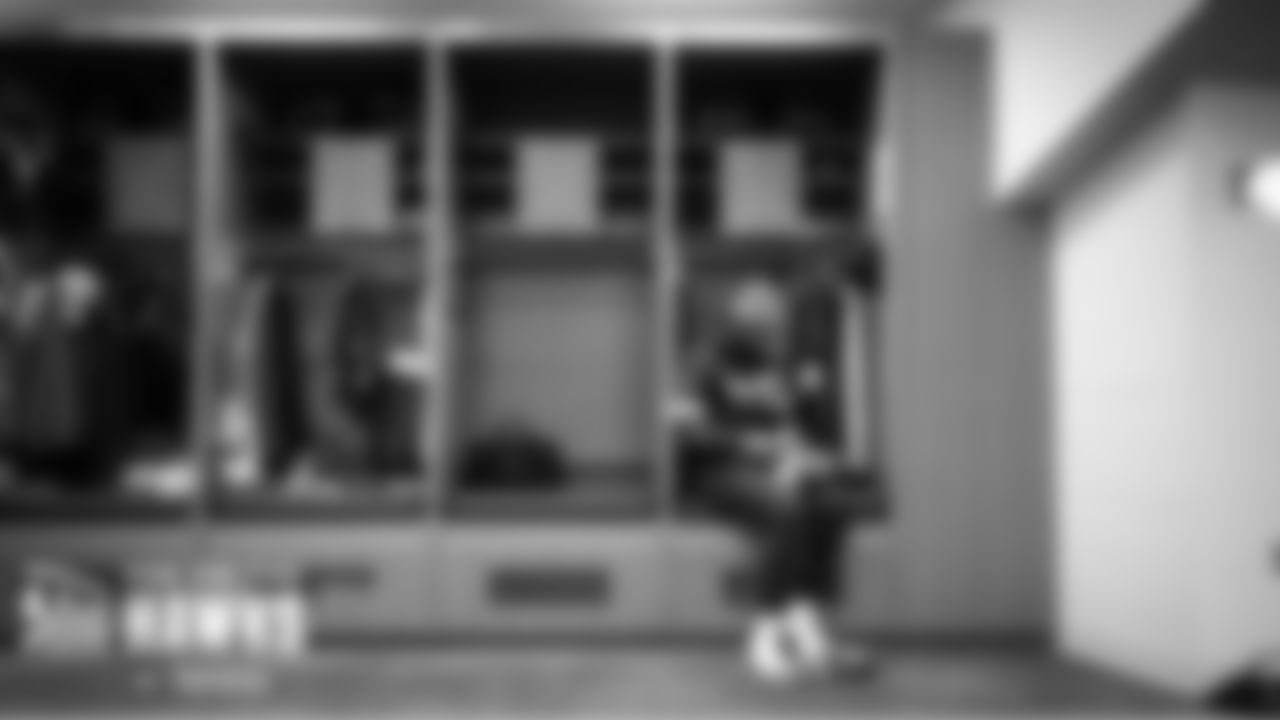 Seahawks quarterback Geno Smith gets ready in the locker room.