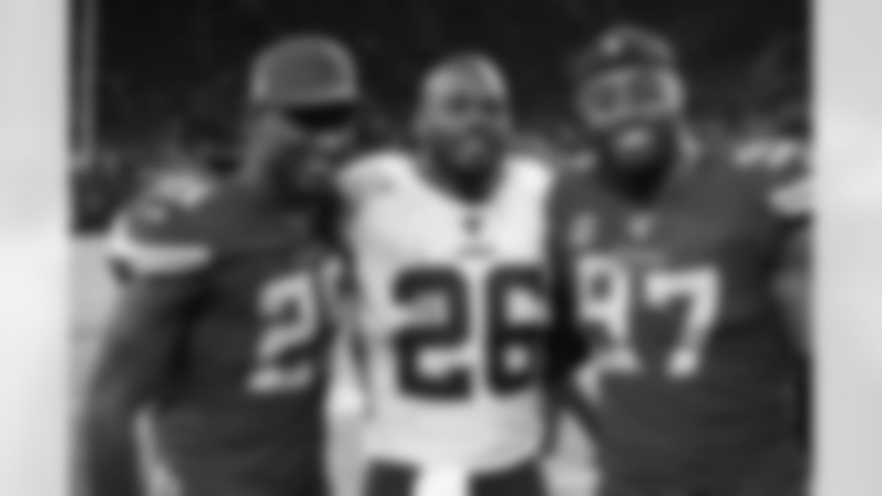 Washington Redskins running back Adrian Peterson (26) poses with Minnesota Vikings cornerback Xavier Rhodes (29) and defensive end Everson Griffen (97) following an NFL football game, Thursday, Oct. 24, 2019, in Minneapolis. The Vikings won 19-9. (AP Photo/Jim Mone)