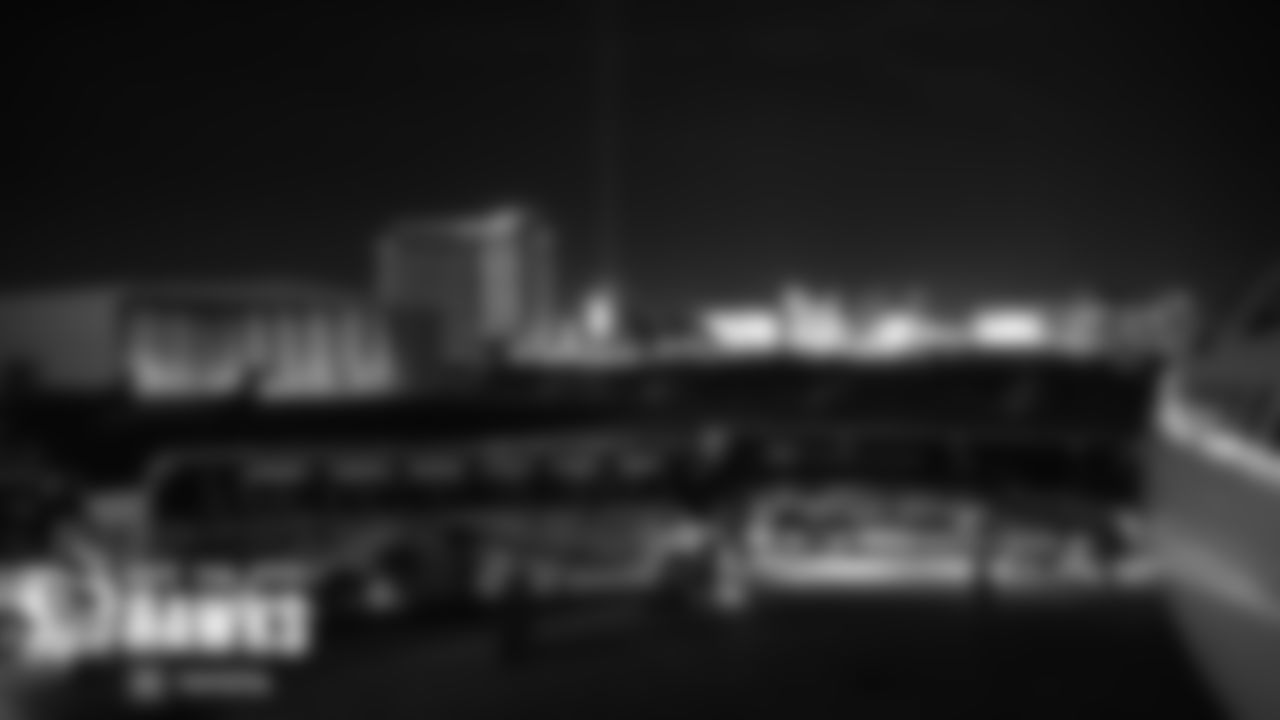 The lights of the Las Vegas strip shine brightly as the Seahawks team buses pull up to their Delta charter for the return trip to Seattle.