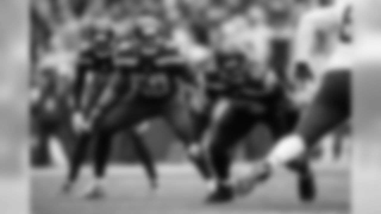 Seattle's Dwight Freeney rushes off the edge with teammates K.J. Wright and Shaquill Griffin lined up behind him.