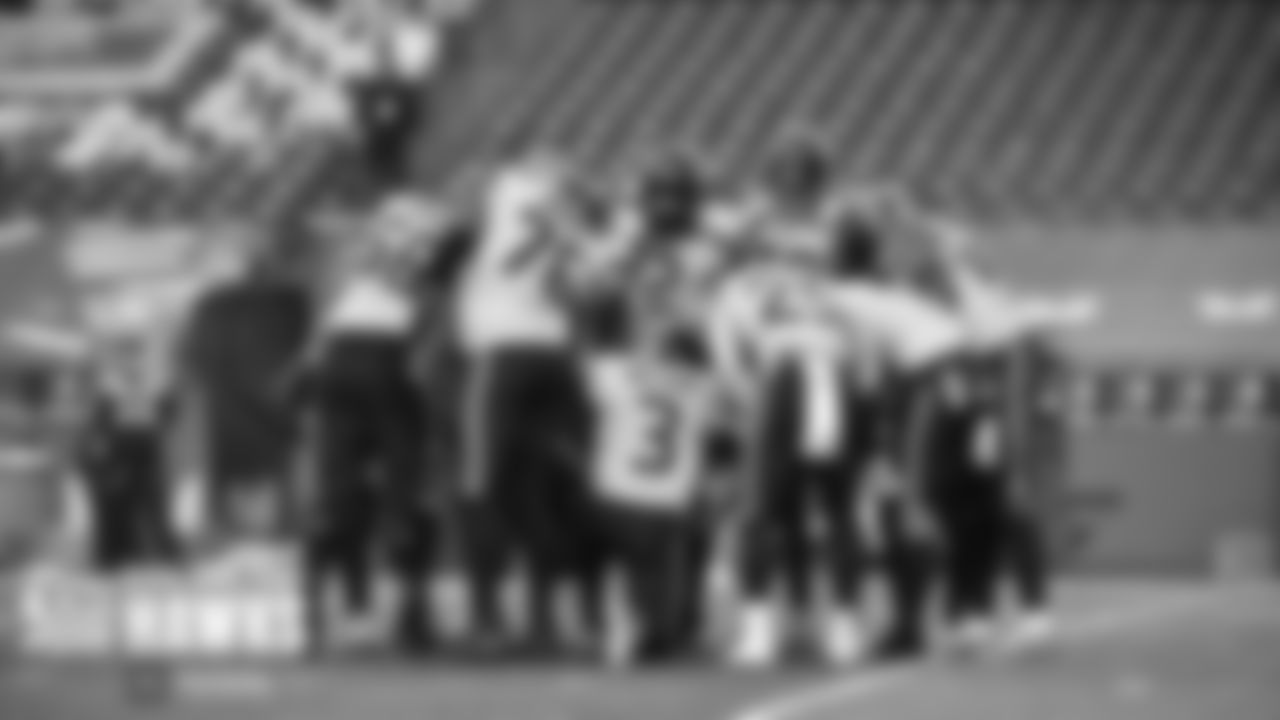 The Seahawks offense huddles around quarterback Russell Wilson.