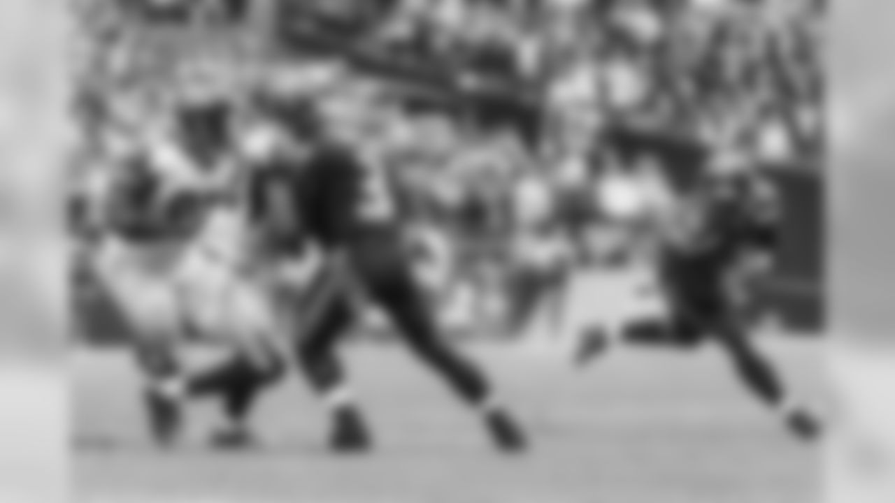 Seahawks quarterback Russell Wilson provides a hard-hitting block to give running back Christine Michael daylight.