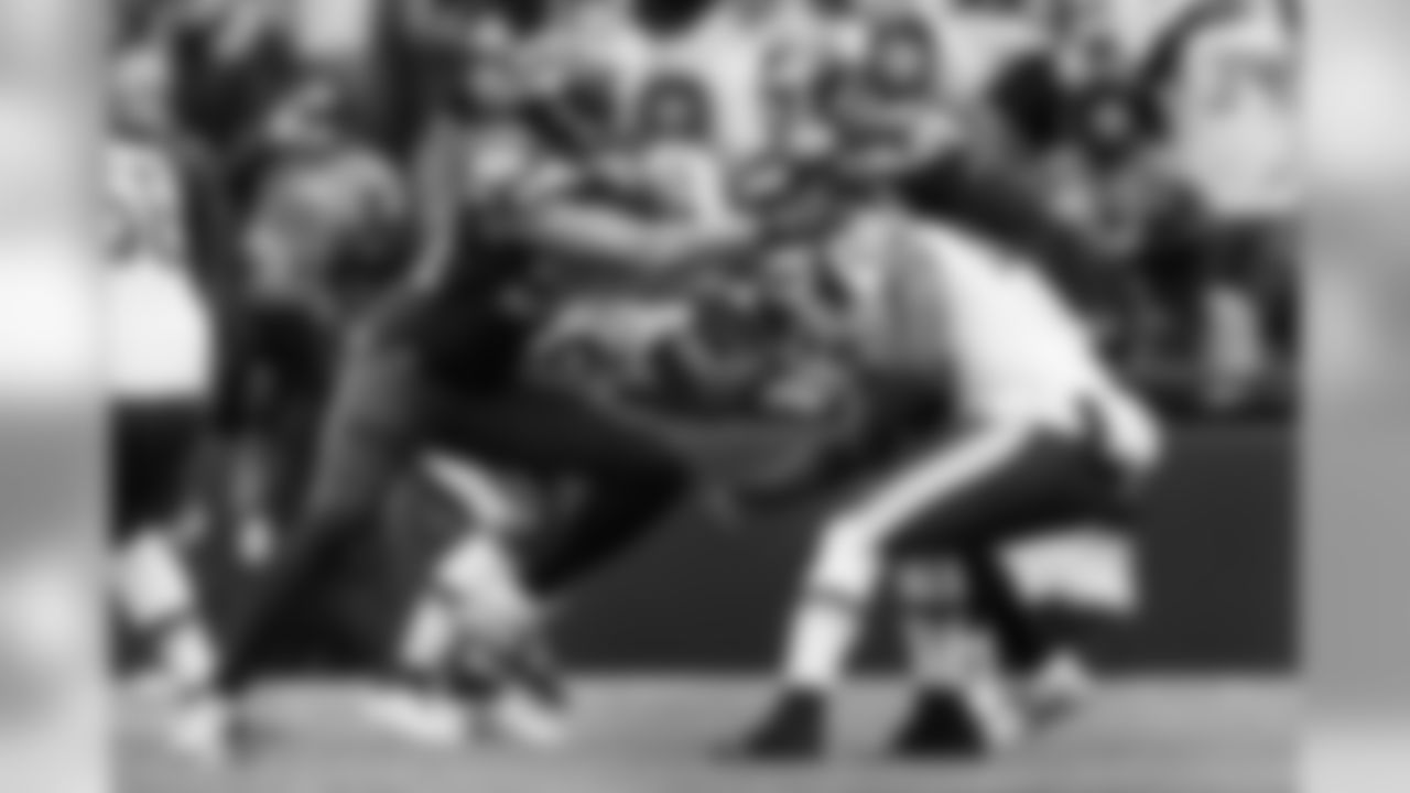 Seattle's K.J. Wright grabs Washington's Rob Kelly to make a tackle.