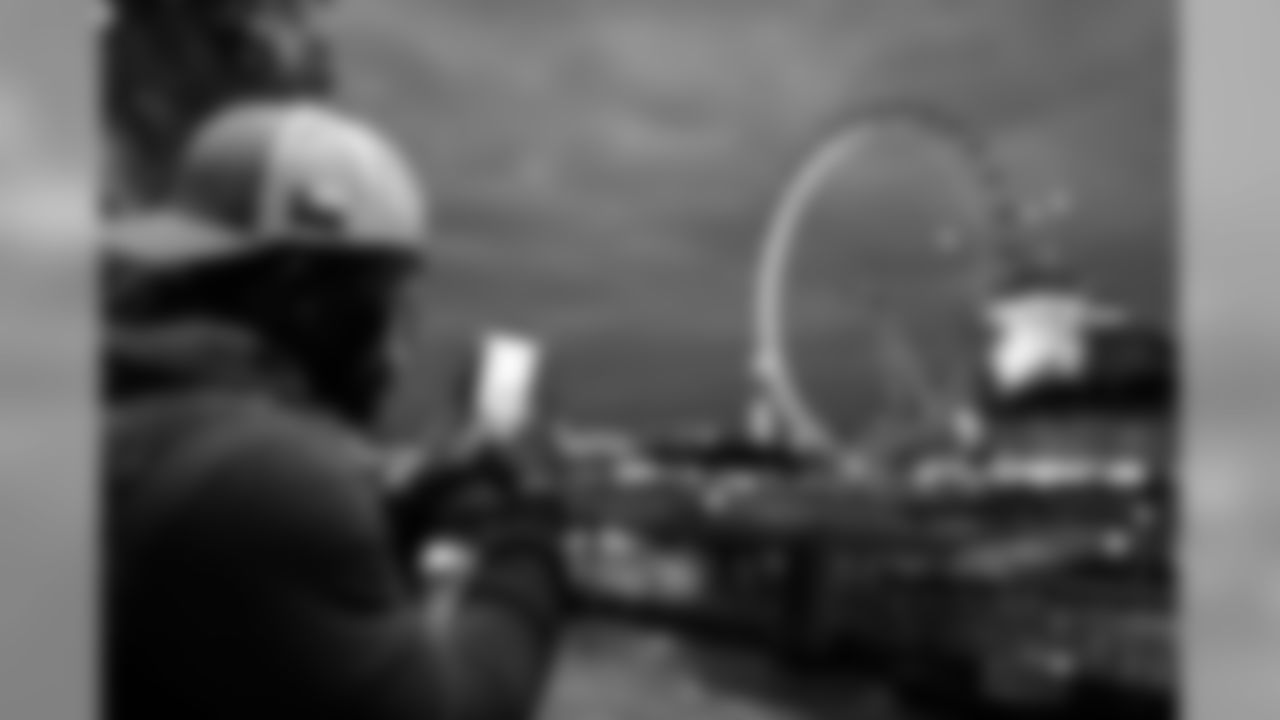 Seahawks receiver David Moore uses his mobile device to photograph the "London Eye", a giant ferris wheel.