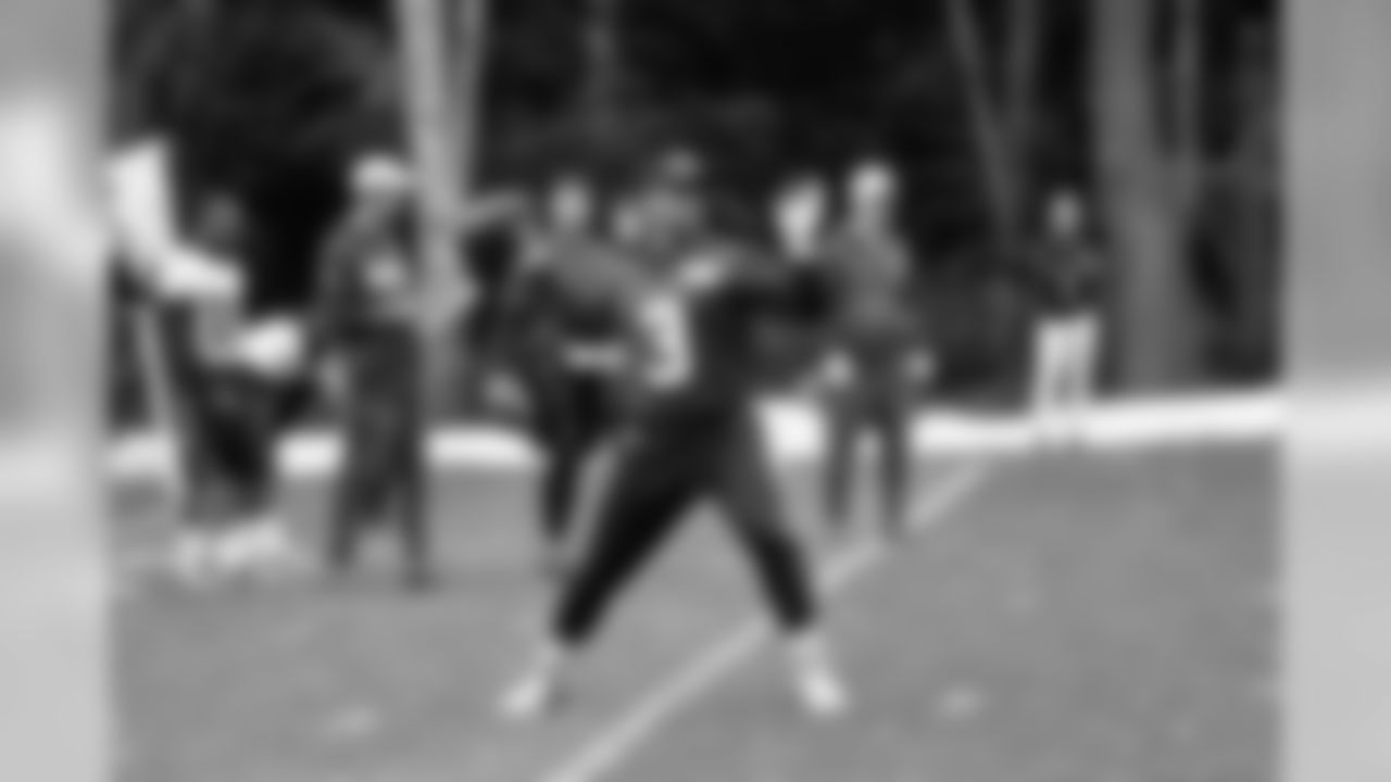 Quarterback Russell Wilson throws a pass during practice.
