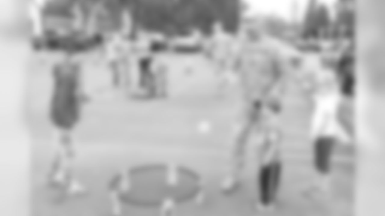 Lieutenant Colonel Thomas Wargo (Deputy G3, Mobilization and Readiness) enjoys a game of Spike Ball with guard youth during the tailgating portion of the Heroes of 12 Tour stop at Camp Murray.