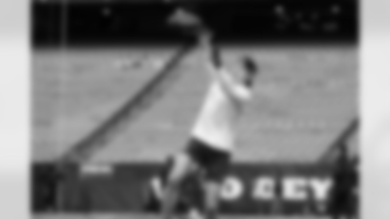 Receiver Jake Bobo reaches high to make a catch during early warmups and he would do the same at a clutch period in the game hours later.