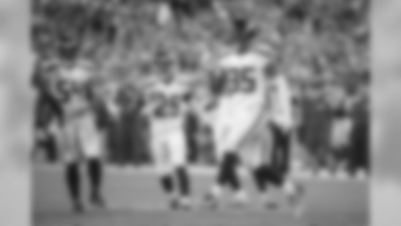 DeShawn Shead celebrates a tackle for loss with teammates Bobby Wagner and Earl Thomas.