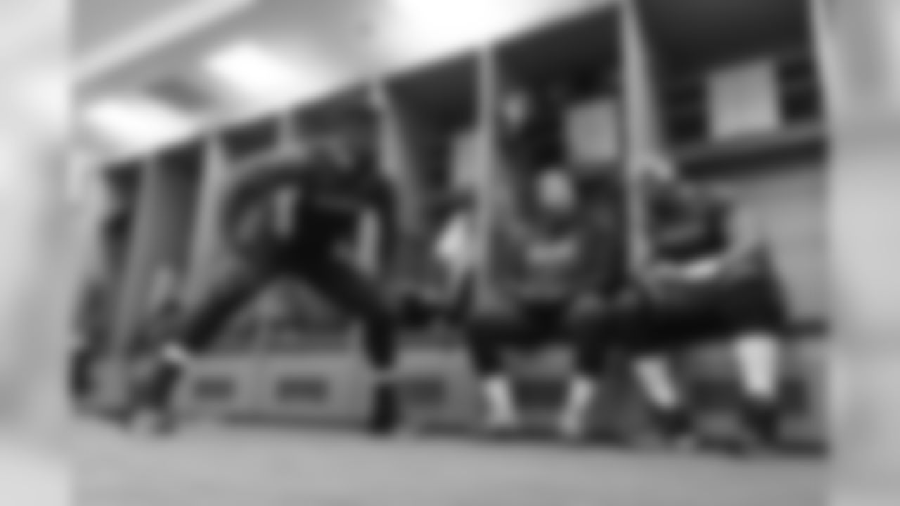 Offensive linemen Germain Ifedi, Mark Glowinski and J'Marcus Russell chat in the locker room prior to the game.