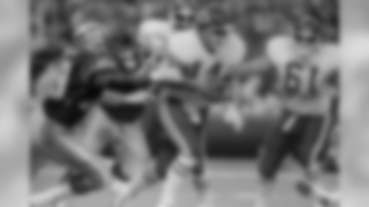 Quarterback Todd Blackledge (14) of the Kansas City Chiefs, is grabbed by Jacob Green (79) of the Seattle Seahawks and sacked for a four-yard loss during the second quarter of their NFL game, Sept. 14, 1986. Also rushing Blackledge is Joe Nash (72) of the Seahawks. Seattle beat Kansas City 23-17. (AP Photo/Gary Stewart)