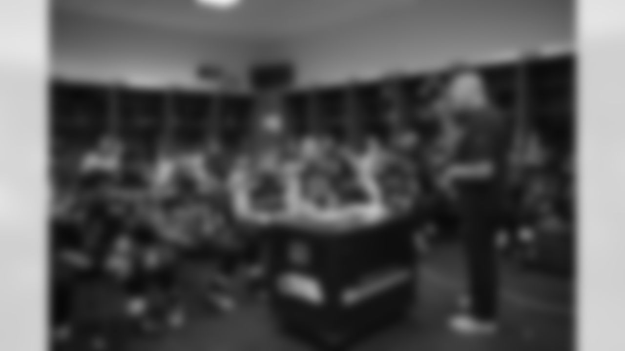 At halftime, assistant head coach Tom Cable addresses the offense.