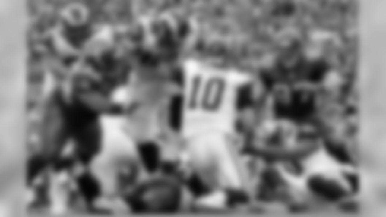 St. Louis Rams quarterback Marc Bulger (10) tries to find an opening before being sacked by Seattle Seahawks' Brandon Mebane, front left, and Seahawks' Patrick Kerney (97) while Rams' Jason Brown, back left, and Jacob Bell (63) try to provide protection in the second half of an NFL football game Sunday, Sept. 13, 2009, in Seattle. (AP Photo/Ted S. Warren)