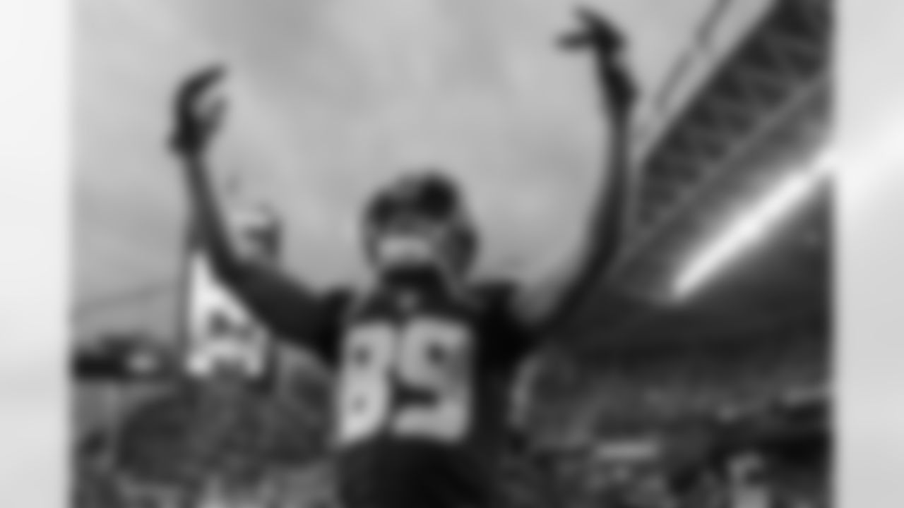 Receiver Doug Baldwin exhorts the crowd as players returned to the field.