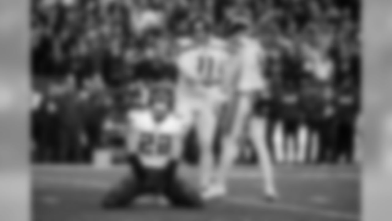 Seahawks kicker Sebastian Janikowski and holder Michael Dickson shake hands after a successful field goal try while Vikings defender Harrison Smith reacts.