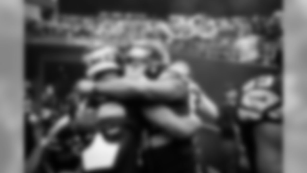 Teammates Chris Carson and David Moore hug before the team is introduced to the crowd at CenturyLink Field.