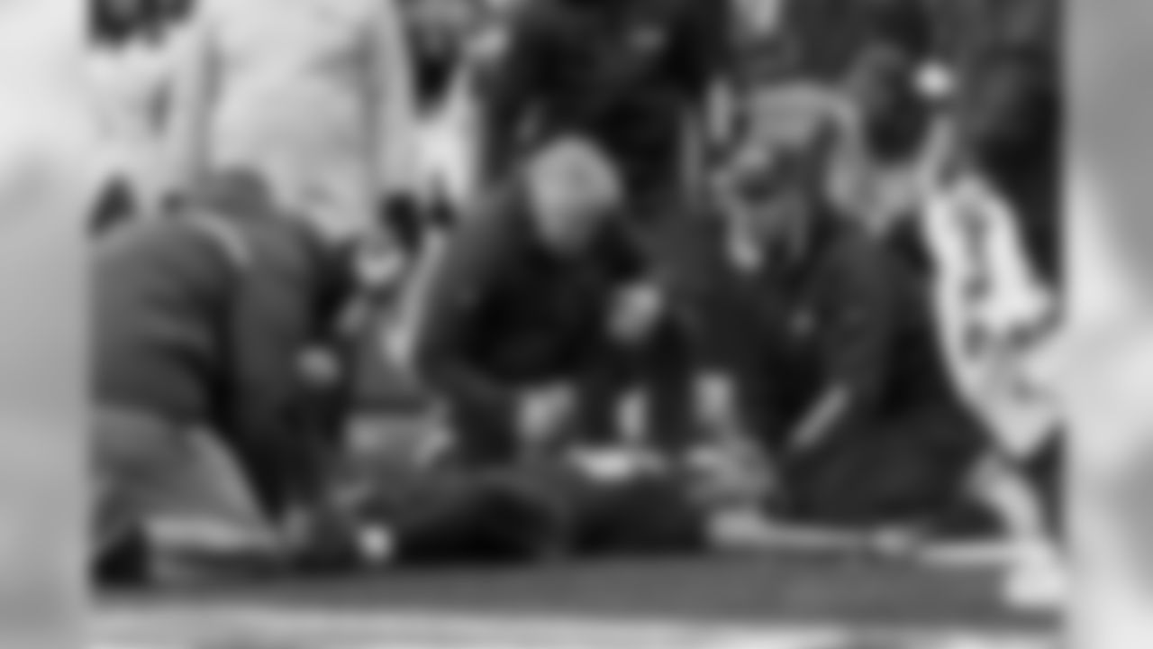 Seattle head coach Pete Carroll comforts receiver Tyler Lockett, who was injured near the goal line after a reception in the second quarter.